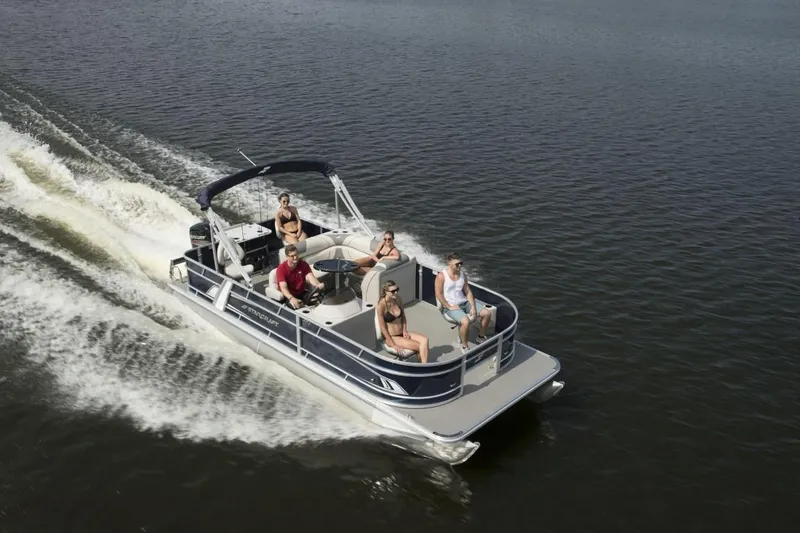 Slide: The Image of 2023 Starcraft EX 22 pontoon boat cruising on a lake with passengers. - 10