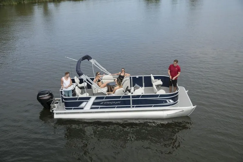 Slide: The Image of 2023 Starcraft EX 22 pontoon boat on a lake with people onboard. - 4
