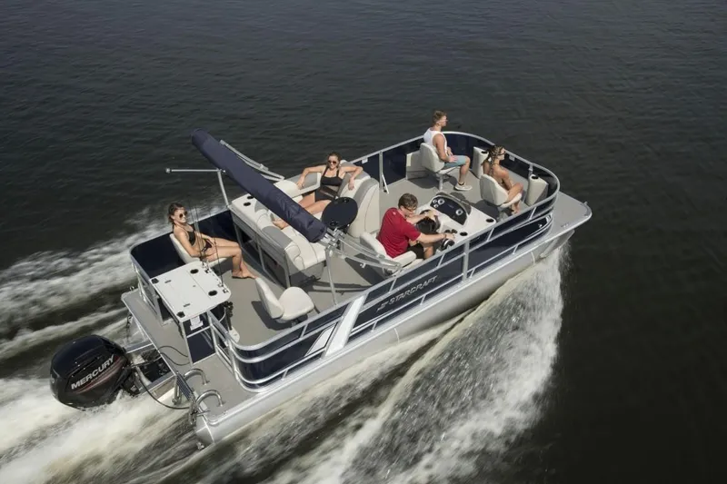 Slide: The Image of 2023 Starcraft EX 22 pontoon boat cruising with passengers on a lake. - 7