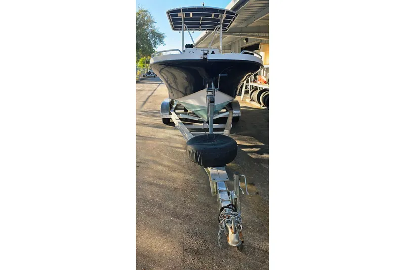 Slide: The Image of 2005 Dusky 203 boat on trailer, parked outdoors, front view. - 4