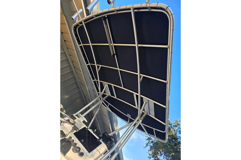 Slide: The Image of T-top canopy of a 2005 Dusky 203 boat, viewed from below against blue sky. - 11
