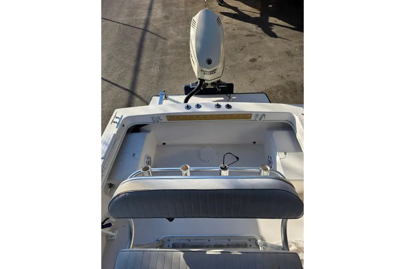 Slide: The Image of 2005 Dusky 203 boat interior with seating and motor, viewed from above. - 14