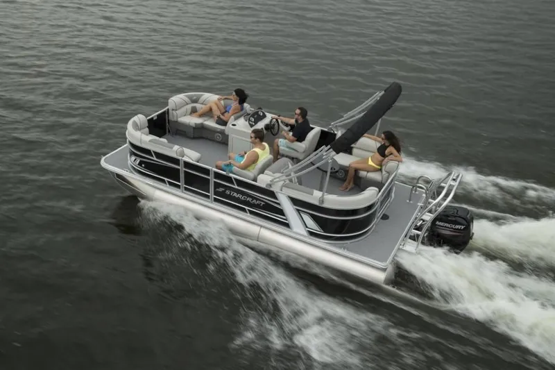 Slide: The Image of 2023 Starcraft EX 24 pontoon boat cruising on water with passengers. - 6
