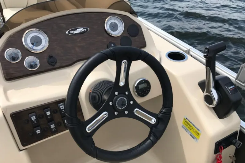 Slide: The Image of 2023 Starcraft EX 24 boat dashboard with steering wheel and controls. - 9
