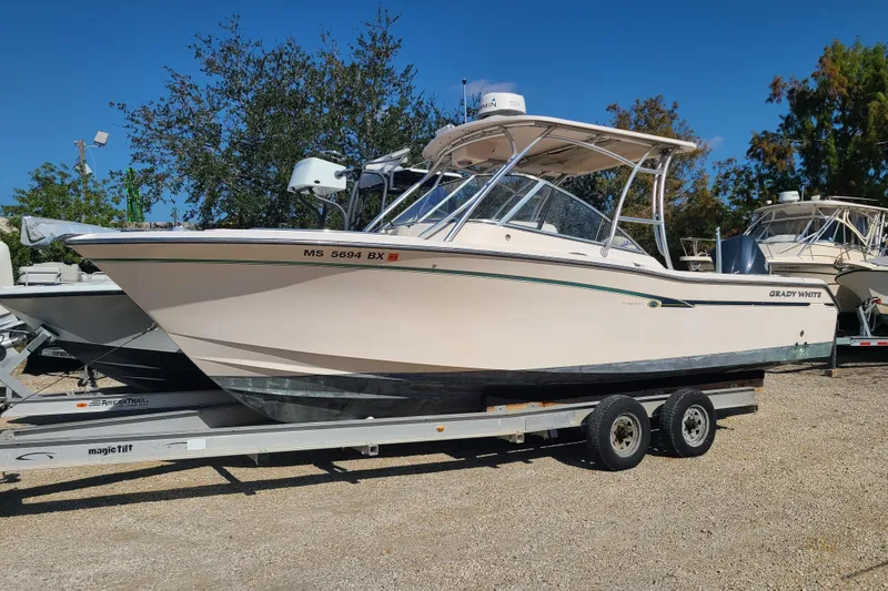 The Image of 2012 Grady-White Freedom 275 boat on trailer, parked outdoors. - 0