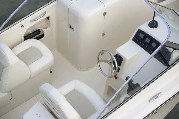 Slide: The Image of 2012 Grady-White Freedom 275 boat docked in a sunny marina setting. - 3