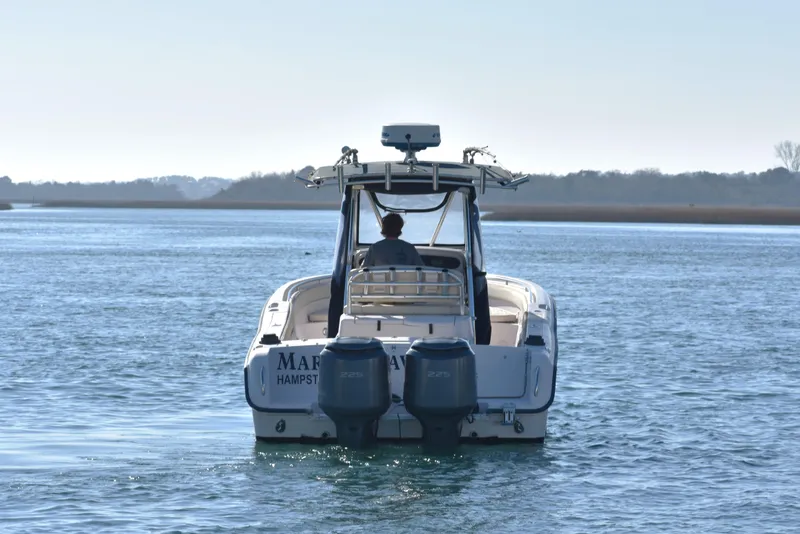 Slide: The Image of 2004 Grady-White Release 283 boat cruising on calm water. - 11