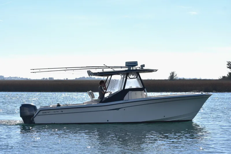 Slide: The Image of 2004 Grady-White Release 283 boat on calm water, side view. - 14