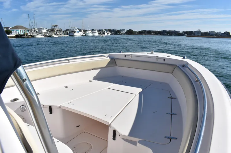 Slide: The Image of 2004 Grady-White Release 283 boat on calm water, clear sky, marina in background. - 16