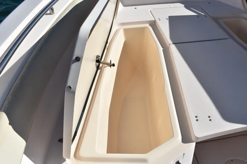 Slide: The Image of Open storage compartment on a 2004 Grady-White Release 283 boat deck. - 19