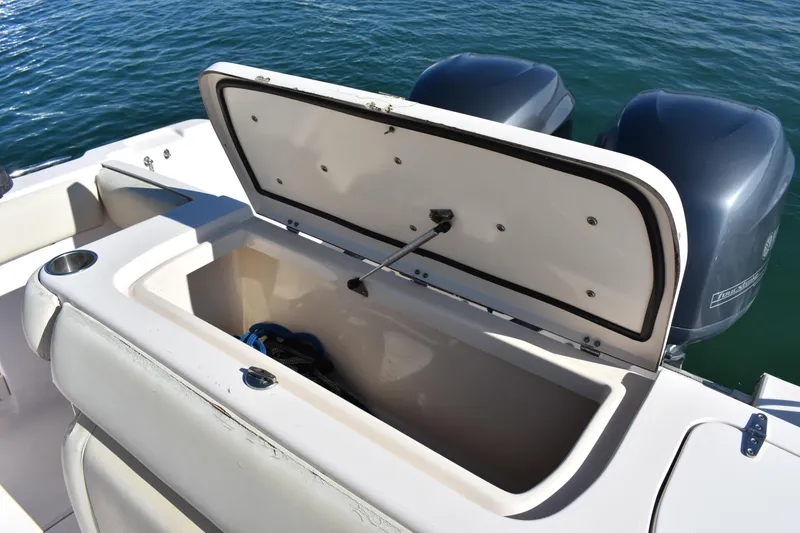 Slide: The Image of 2004 Grady-White Release 283 boat with open storage compartment and dual engines. - 24