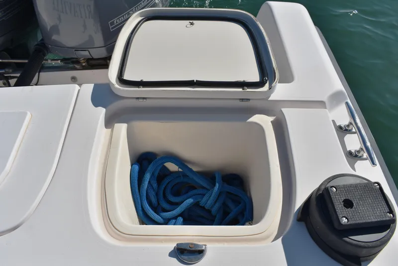 Slide: The Image of Open storage compartment on 2004 Grady-White Release 283 boat with blue rope inside. - 25