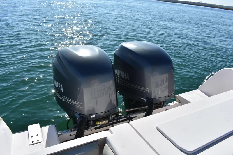 Slide: The Image of Twin Yamaha outboard engines on a 2004 Grady-White Release 283 boat in sparkling water. - 28