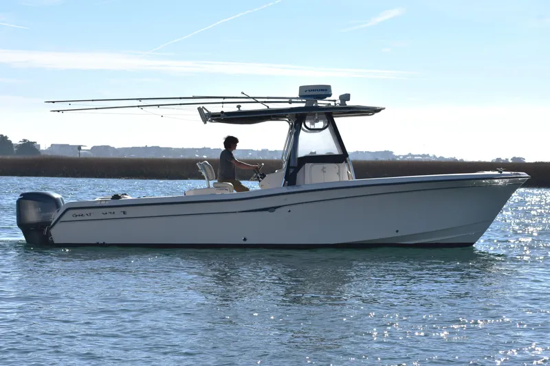 Slide: The Image of 2004 Grady-White Release 283 boat on water, side view, clear sky background. - 9