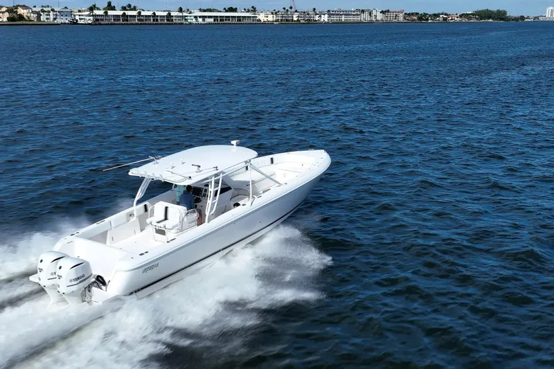 Slide: The Image of 2011 Intrepid 400 Center Console boat cruising on open water. - 12