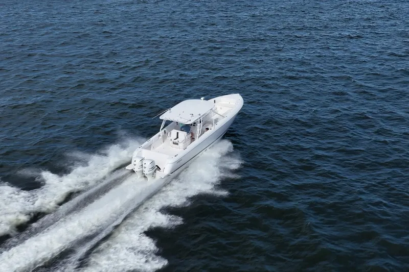 Slide: The Image of 2011 Intrepid 400 Center Console boat cruising on open water. - 13