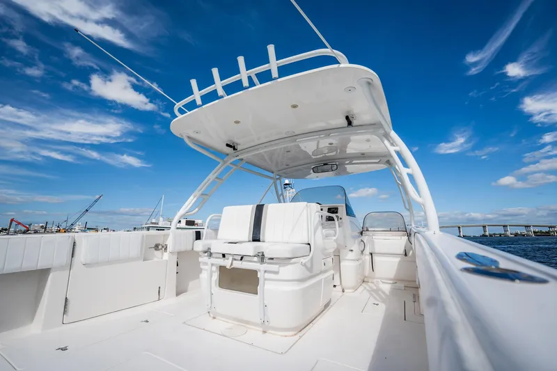 Slide: The Image of 2011 Intrepid 400 Center Console boat with sleek design, open deck, and blue sky backdrop. - 18