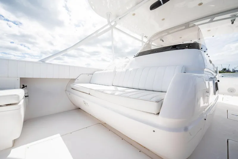 Slide: The Image of 2011 Intrepid 400 Center Console boat interior with white seating under a cloudy sky. - 21