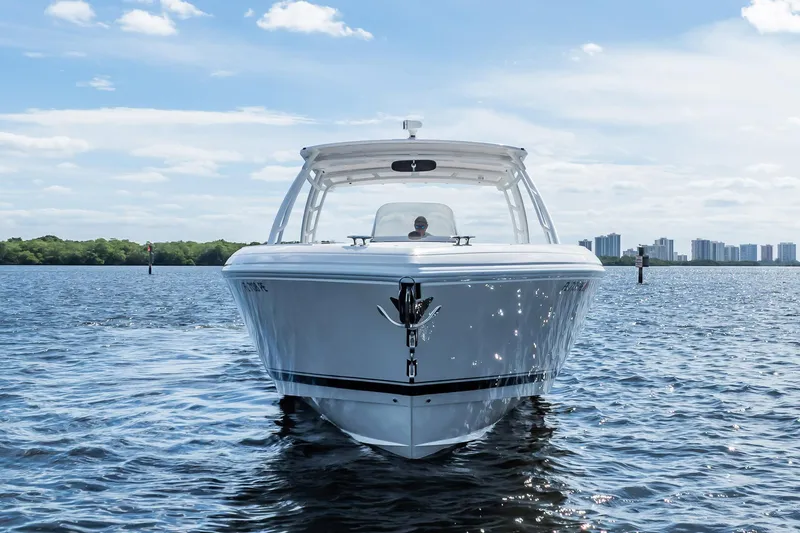 Slide: The Image of 2011 Intrepid 400 Center Console boat on calm water, city skyline in background. - 28