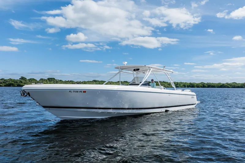 Slide: The Image of 2011 Intrepid 400 Center Console boat on calm water under blue sky. - 3