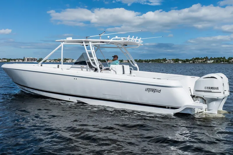 Slide: The Image of 2011 Intrepid 400 Center Console boat cruising on water under blue sky. - 4