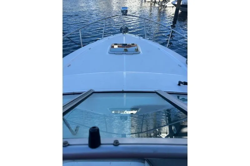 Slide: The Image of 2014 Rinker 260 Express Cruiser on calm water, view from the bow. - 22