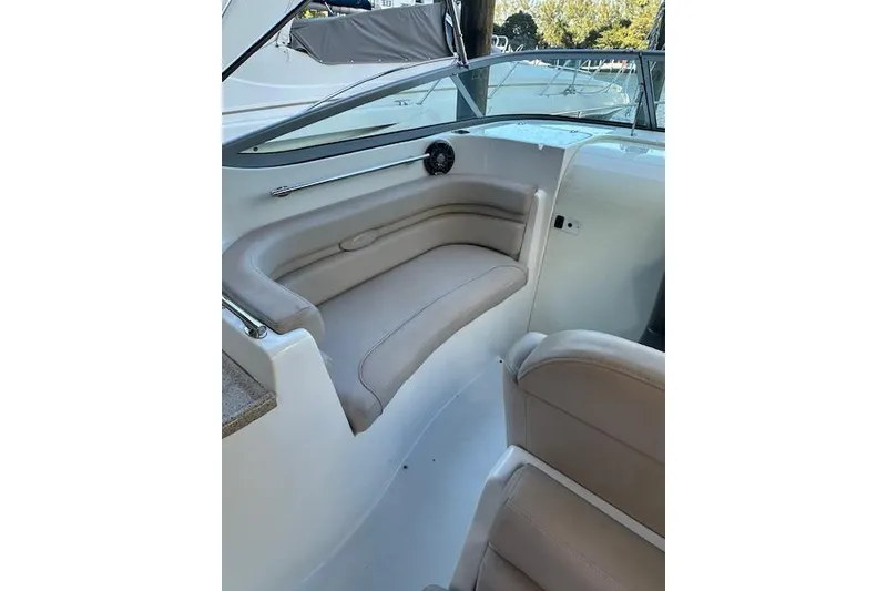 Slide: The Image of 2014 Rinker 260 Express Cruiser interior with beige seating and sleek design. - 9