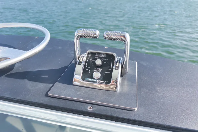 Slide: The Image of Throttle controls on a 1997 Garlington 61 boat, with water in the background. - 13