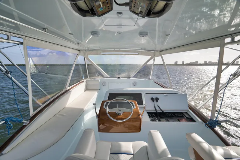 Slide: The Image of Interior view of a 1997 Garlington 61 yacht, showcasing helm and seating area. - 14
