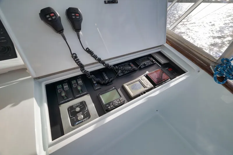 Slide: The Image of Control panel of a 1997 Garlington 61 boat with communication devices and navigation instruments. - 19