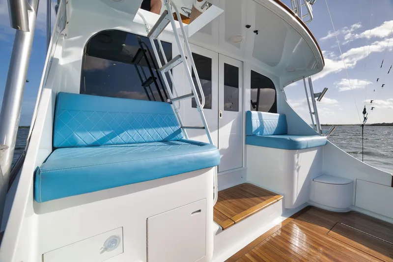 Slide: The Image of Luxurious 1997 Garlington 61 yacht with blue seating and wooden deck. - 28