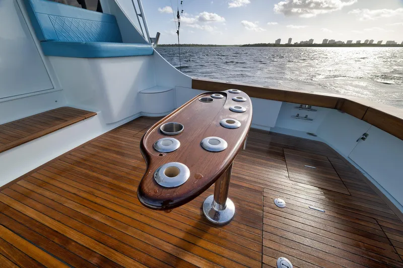 Slide: The Image of 1997 Garlington 61 yacht deck with wooden flooring and fishing rod holders. - 29