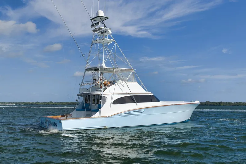 Slide: The Image of 1997 Garlington 61 yacht cruising on open water under a clear blue sky. - 3