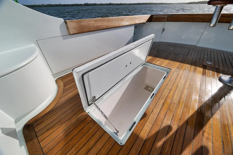 Slide: The Image of Open storage compartment on 1997 Garlington 61 boat with wooden deck. - 30