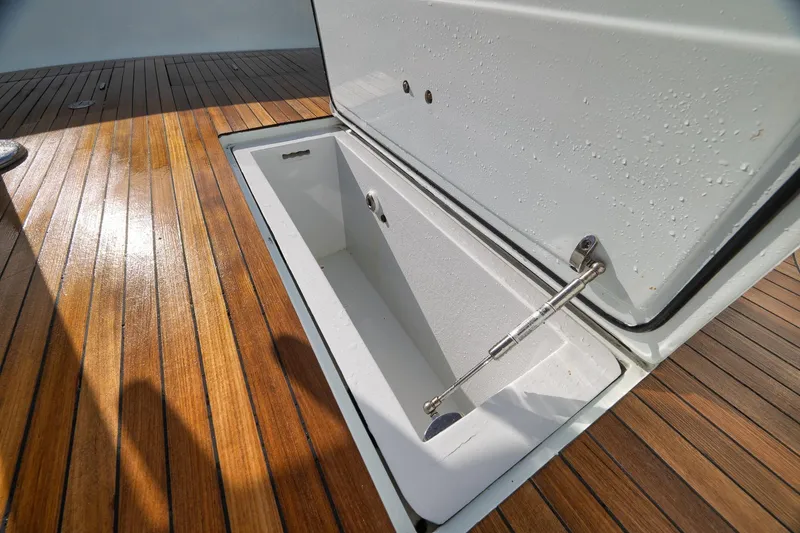 Slide: The Image of Open storage compartment on 1997 Garlington 61 yacht with teak deck. - 31