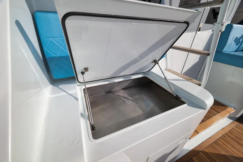 Slide: The Image of Open storage compartment on 1997 Garlington 61 boat with blue seating. - 32