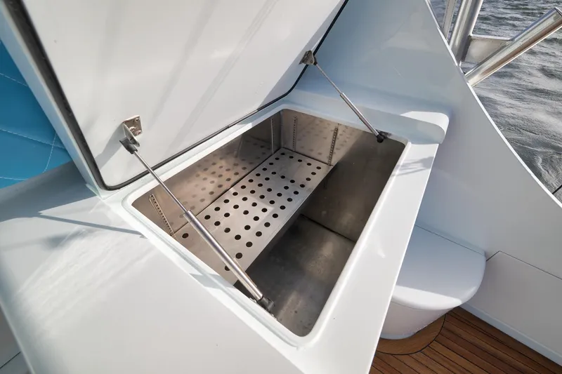 Slide: The Image of Open storage compartment on 1997 Garlington 61 boat with metal interior. - 34