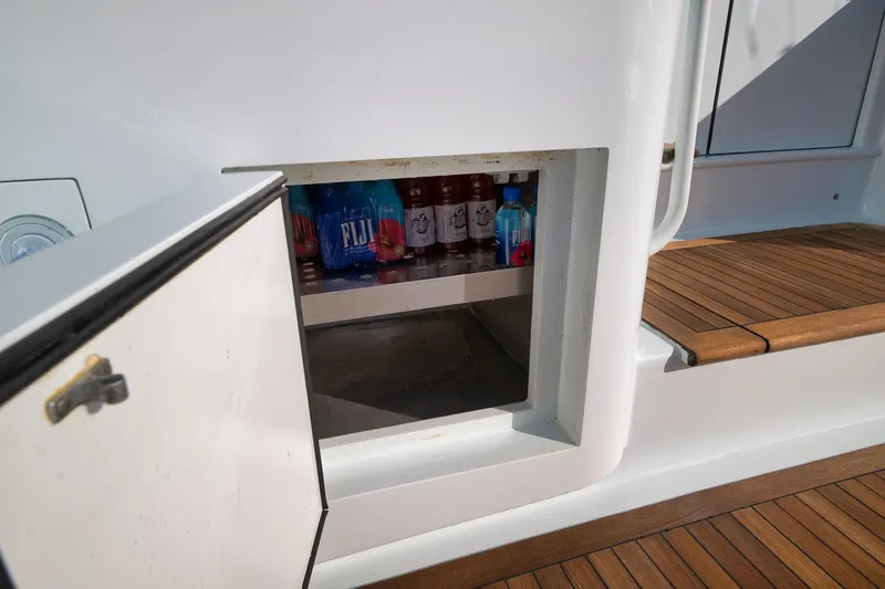 Slide: The Image of Open storage compartment on 1997 Garlington 61 yacht with drinks inside. - 35