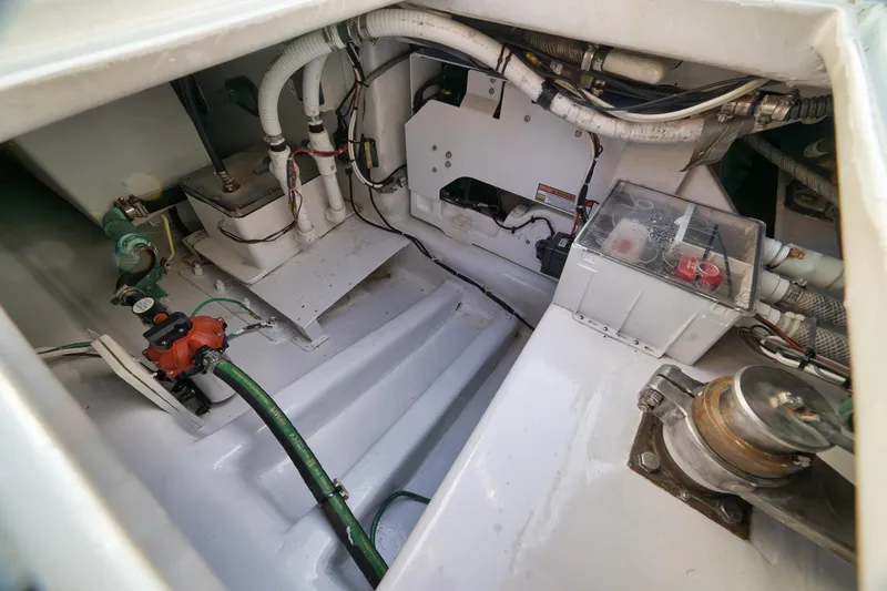 Slide: The Image of Engine compartment of a 1997 Garlington 61 boat, showcasing mechanical components and wiring. - 38