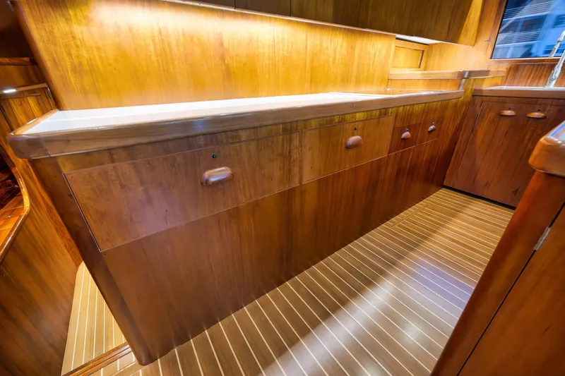 Slide: The Image of Luxurious wooden interior of a 1997 Garlington 61 yacht, featuring elegant cabinetry and flooring. - 47