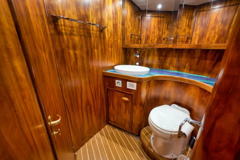 Slide: The Image of Luxurious wooden bathroom interior in a 1997 Garlington 61 yacht, featuring modern fixtures. - 55