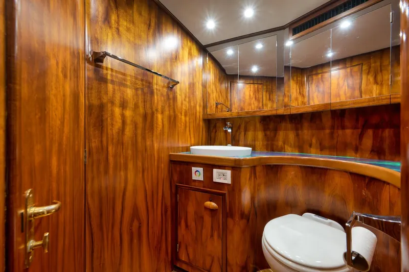 Slide: The Image of Luxurious wooden bathroom interior in 1997 Garlington 61 yacht, featuring sink and toilet. - 56