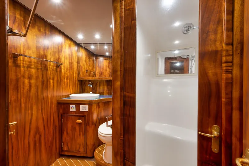 Slide: The Image of Luxurious wooden bathroom interior on a 1997 Garlington 61 yacht, featuring modern fixtures. - 57