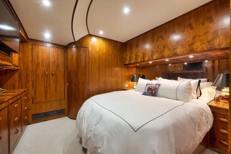 Slide: The Image of Luxurious wooden cabin interior on a 1997 Garlington 61 yacht, featuring a cozy bed. - 58