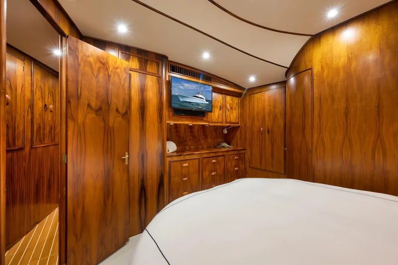 Slide: The Image of Luxurious wooden interior of a 1997 Garlington 61 yacht cabin with TV and ambient lighting. - 59
