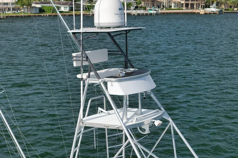 Slide: The Image of 1997 Garlington 61 yacht tower with radar, overlooking calm waters and waterfront homes. - 6
