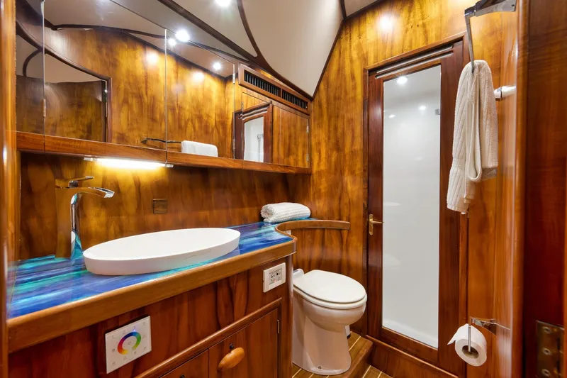 Slide: The Image of Luxurious wooden bathroom interior on a 1997 Garlington 61 yacht, featuring modern fixtures. - 61
