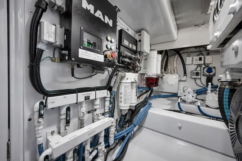 Slide: The Image of Engine room of a 1997 Garlington 61 yacht with complex machinery and wiring. - 70