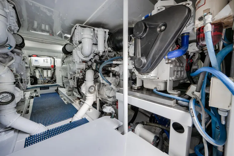Slide: The Image of Engine room of a 1997 Garlington 61 yacht, showcasing complex machinery and piping. - 71