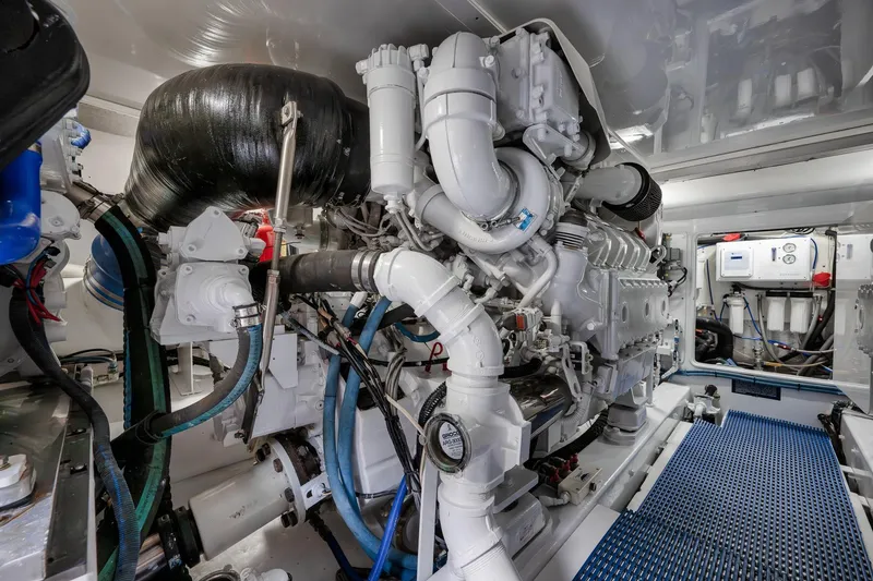 Slide: The Image of Engine room of a 1997 Garlington 61 yacht, showcasing complex machinery and piping. - 72